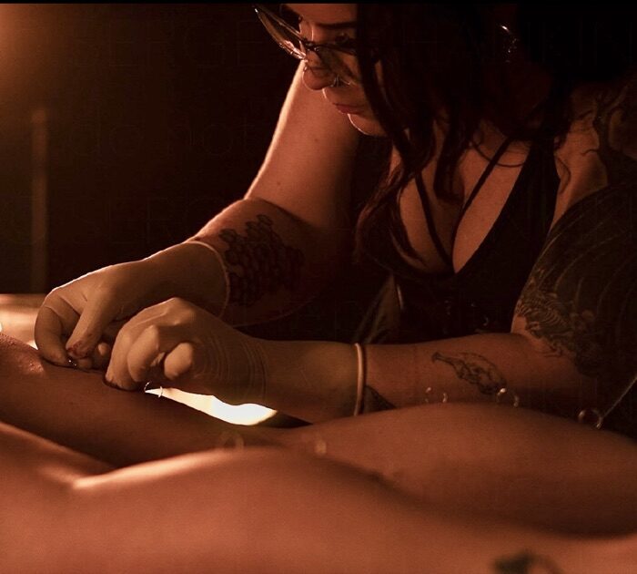 Piercing session by candlelight at Lumen Piercing